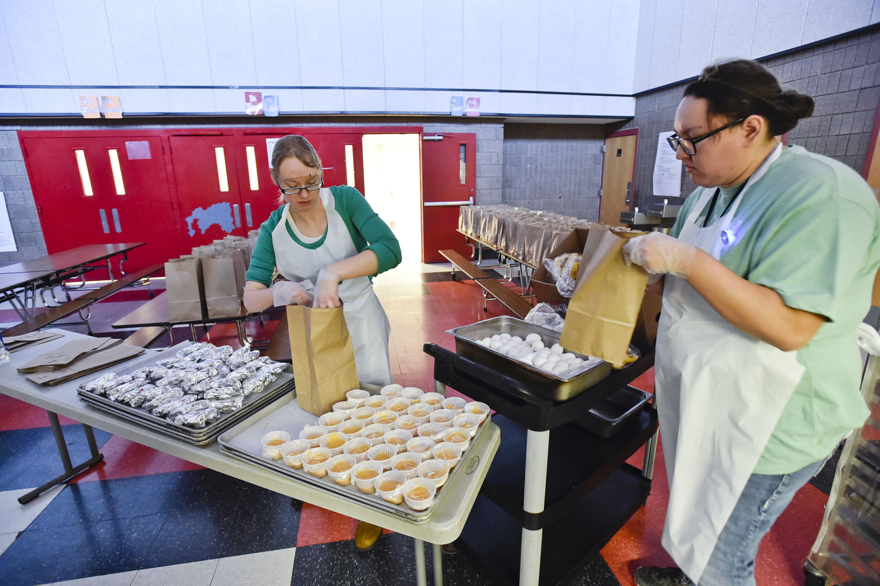 Laura Hall, left, and Ashley Blackman bag three hundred sack breakfasts
